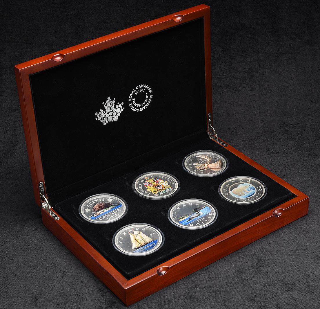 Hinged wooden box, open, black velvet lined, 6 oversized versions of current Canadian coins with coloured images.