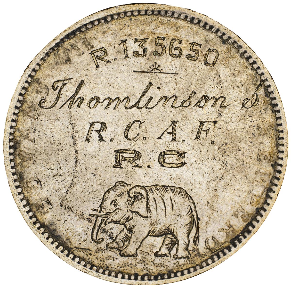 Silver coin, smoothed, re-engraved with the name of a military organization along with an elephant.