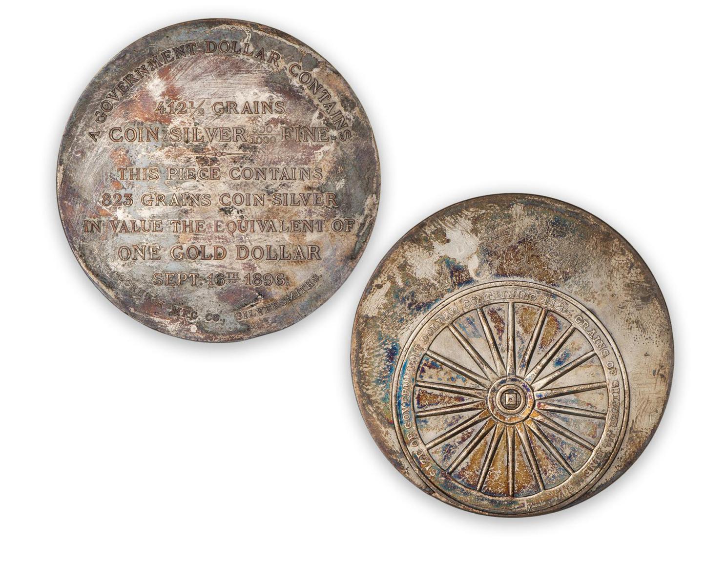 FToken, round, silver, tarnished, long description on one side, a wheel on the other.