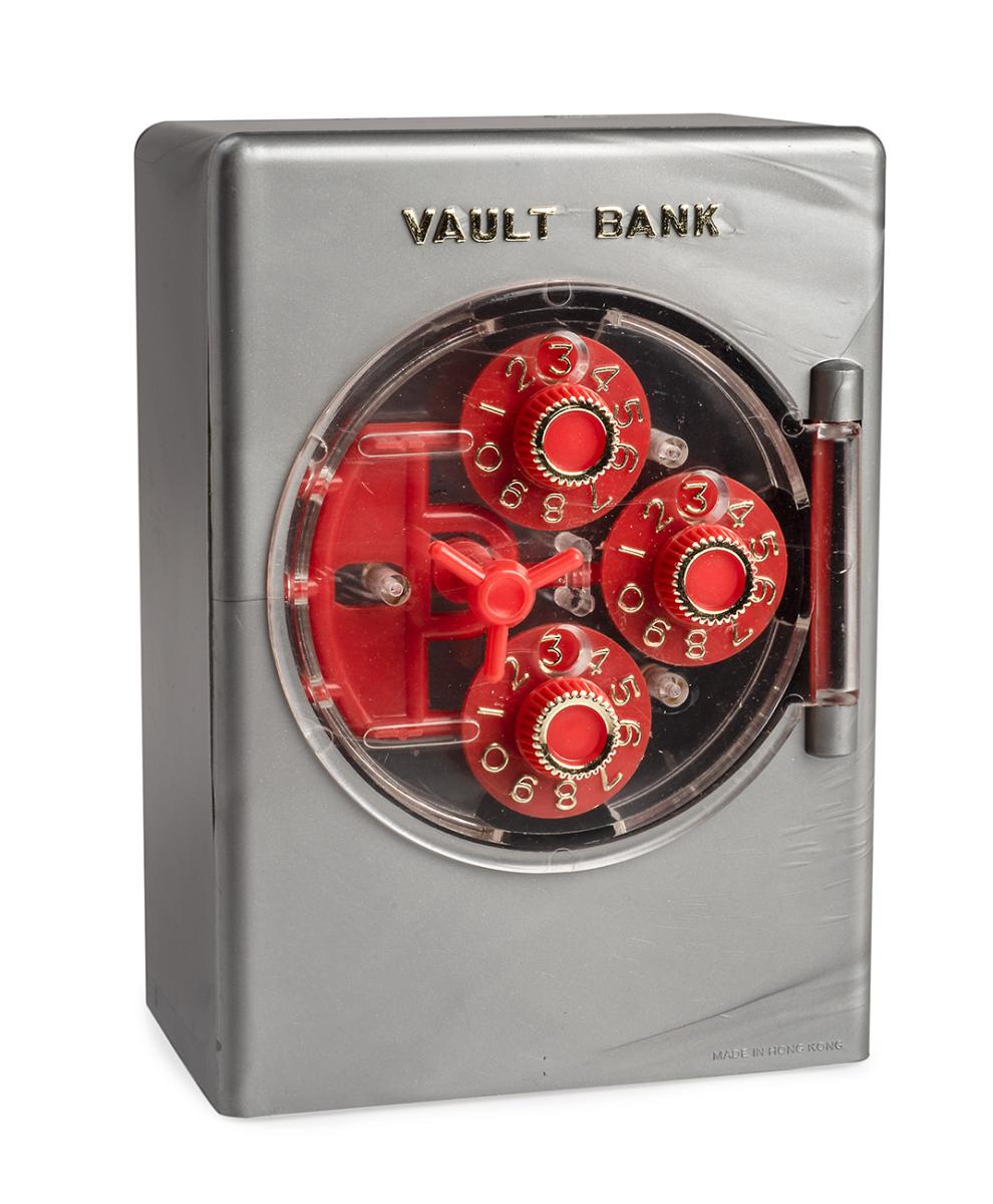 Grey plastic box shaped like a bank vault with three dials on front.