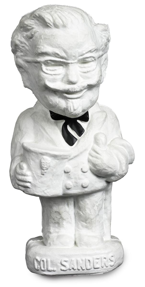 Model of an elderly man with a goatee beard in a white suit and a string tie.