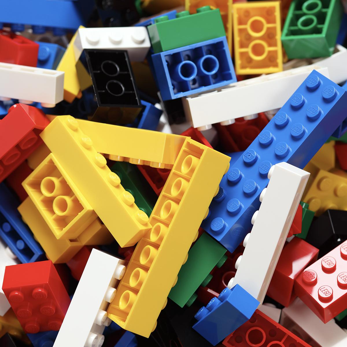 Pile of brightly coloured building blocks of different sizes.
