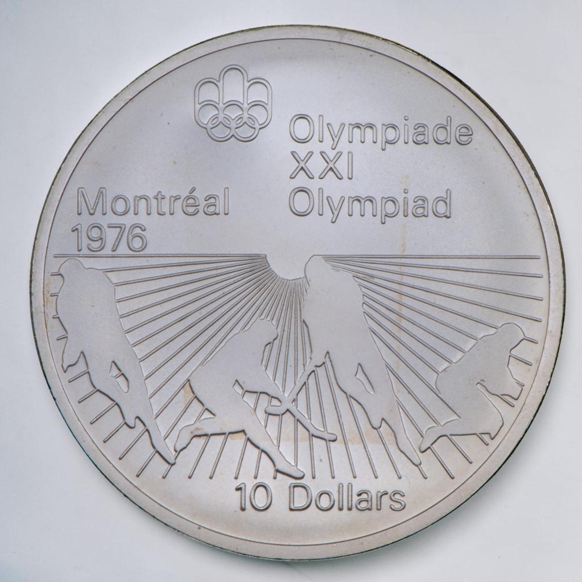 Coin, silver, sunburst pattern on bottom half with outlines of team players with bent sticks.
