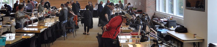 Room of tables with people selling coins and bank notes