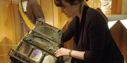 Woman taking coin from a case