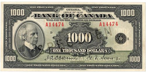 Bank note, pale green, elaborate geometric patterns, a balding man in an old-fashioned high-collared suit: Sir Wilfrid Laurier.