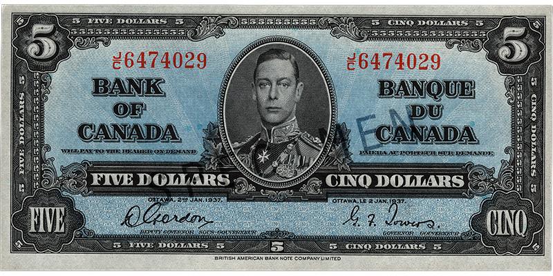 Bank note, blue, elaborate geometric patterns, a young man in an old-fashioned military uniform: King George VI.