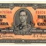 Bank note, orange, elaborate geometric patterns, a young man in an old-fashioned military uniform: King George VI.