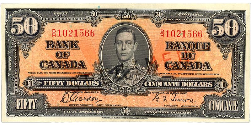 Bank note, orange, elaborate geometric patterns, a young man in an old-fashioned military uniform: King George VI.