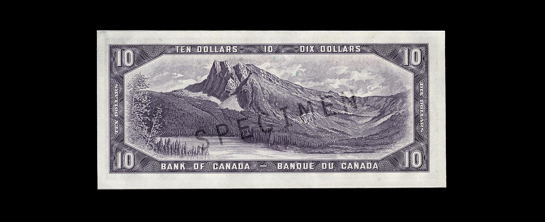 Bank note, purple, a frame of geometric patterns, a lake, forested foothills and a pyramid-shaped mountain peak.