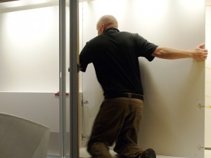 Man on knees in a display case