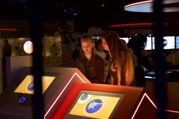 two young people at a digital terminal