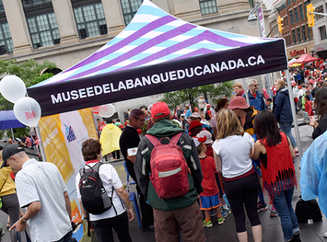 crowd of people at a tent booth