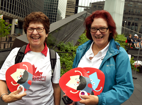 two women holding promotional fans