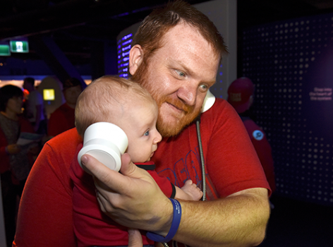 man and baby with headphones