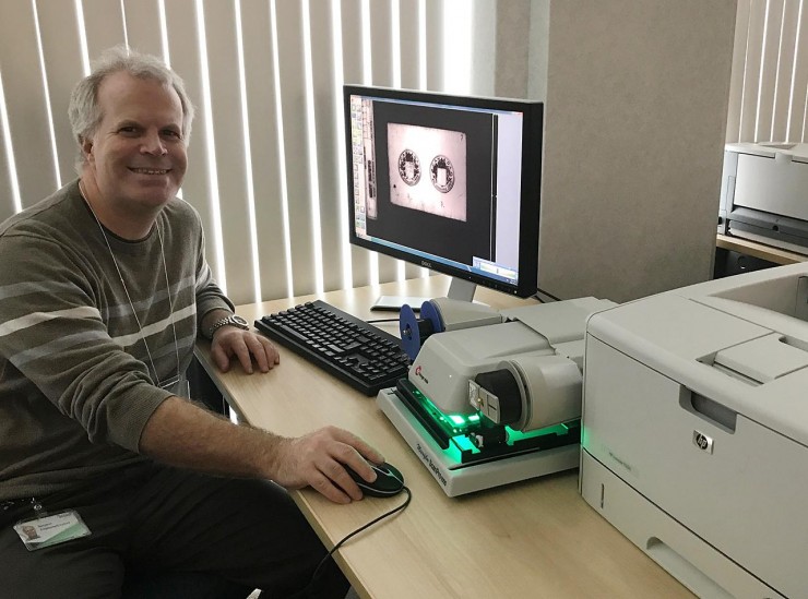 man at a microfilm machine