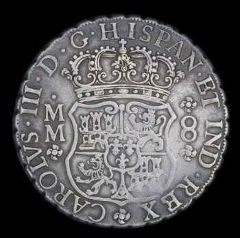 old coin with Spanish coat of arms