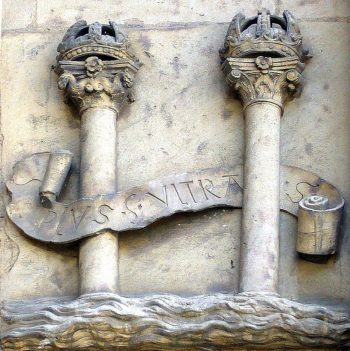 stone carving of two pillars with ribbon around them