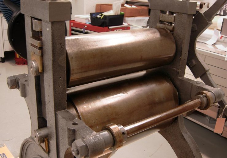 19th century print press showing oiled cylinders