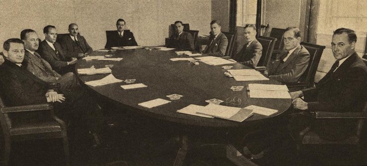 black and white image of men around a boardroom table