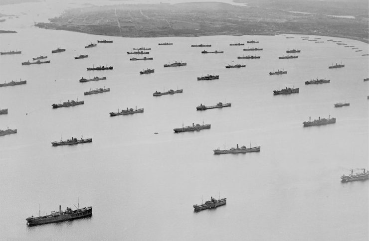 black and white photo of cargo ships in harbour