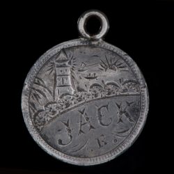 Hand engraved token with lighthouse