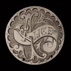 Hand engraved token with “Alice”