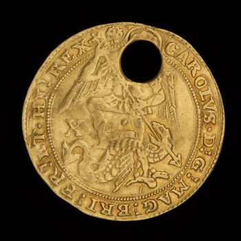 Front of a pierced gold coin with St. Michael slaying a dragon