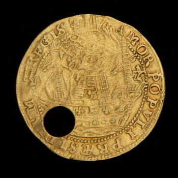 Back of a pierced gold coin with a ship