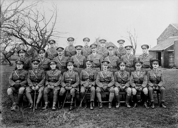 twenty-one Canadian First World War officers pose in rows on a farm