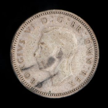 Old coin with image of King George VI