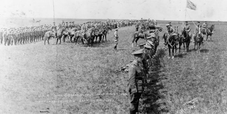 black and white photo showing rows of soldiers on the prairies