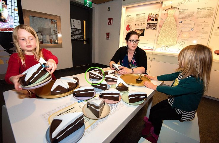 children at a table covered in make-believe cake slices