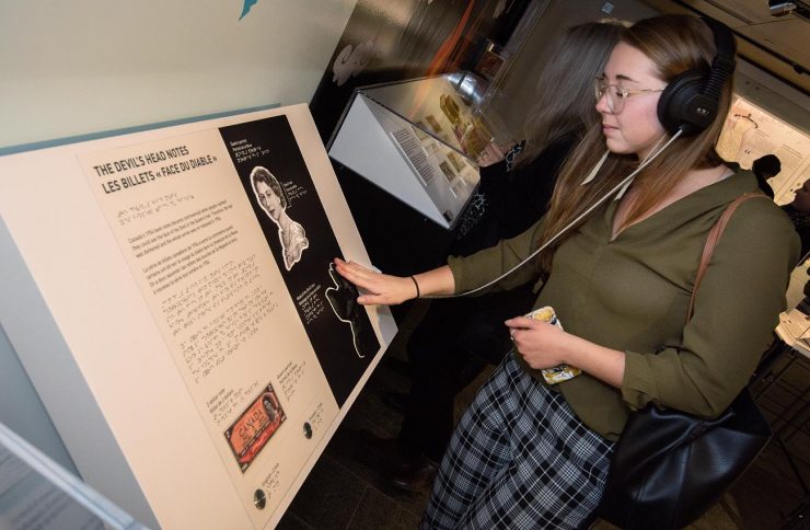 woman touching an exhibition element