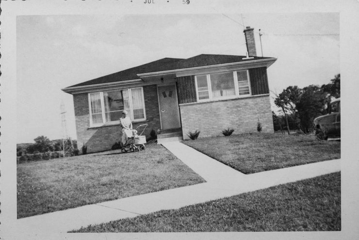 Black and white photograph of a 1950s suburban house.