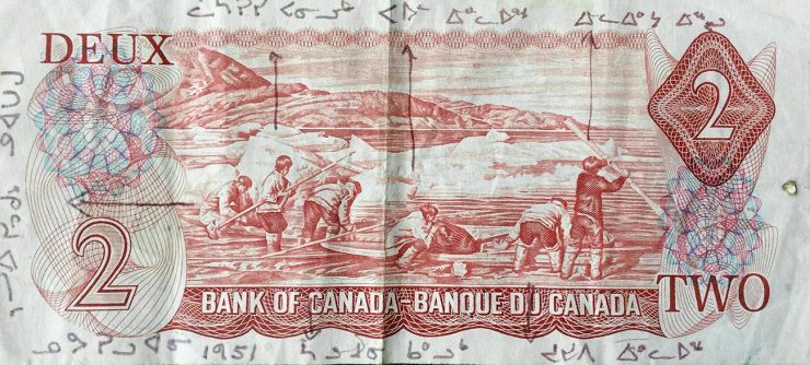 $2 bill featuring Inuit hunting scene with each hunter labelled in Inuktitut.