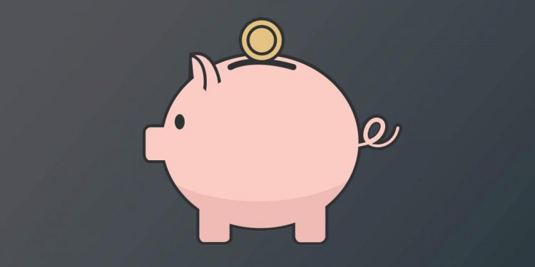 A piggy bank with a coin entering the slot.