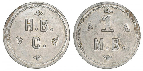 A grey metal token with “H.B.C.” on one side and “1 M.B.” on the other.