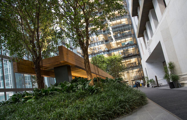 Building, old, grey stone, inside a tree-filled atrium.