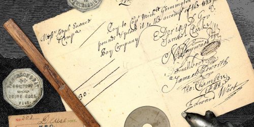 Photo collage, yellowed document with writing, tokens, carved stick, silver beaver trinket.