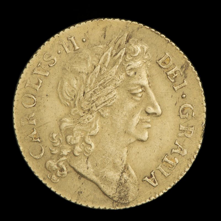 Coin, gold, Latin text around the edges, a man’s head in profile facing right.