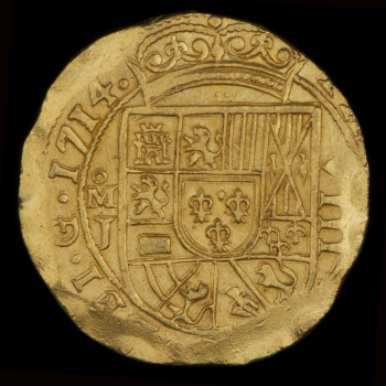 Coin, gold, roughly round, Latin text at the edges and off-centred surrounding a crowned coat of arms.