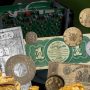 Photo collage, old bank notes and coins, gold nuggets and a computer component.