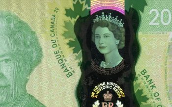 Bank note, close-up portrait of a woman wearing a tiara printed in a clear window.