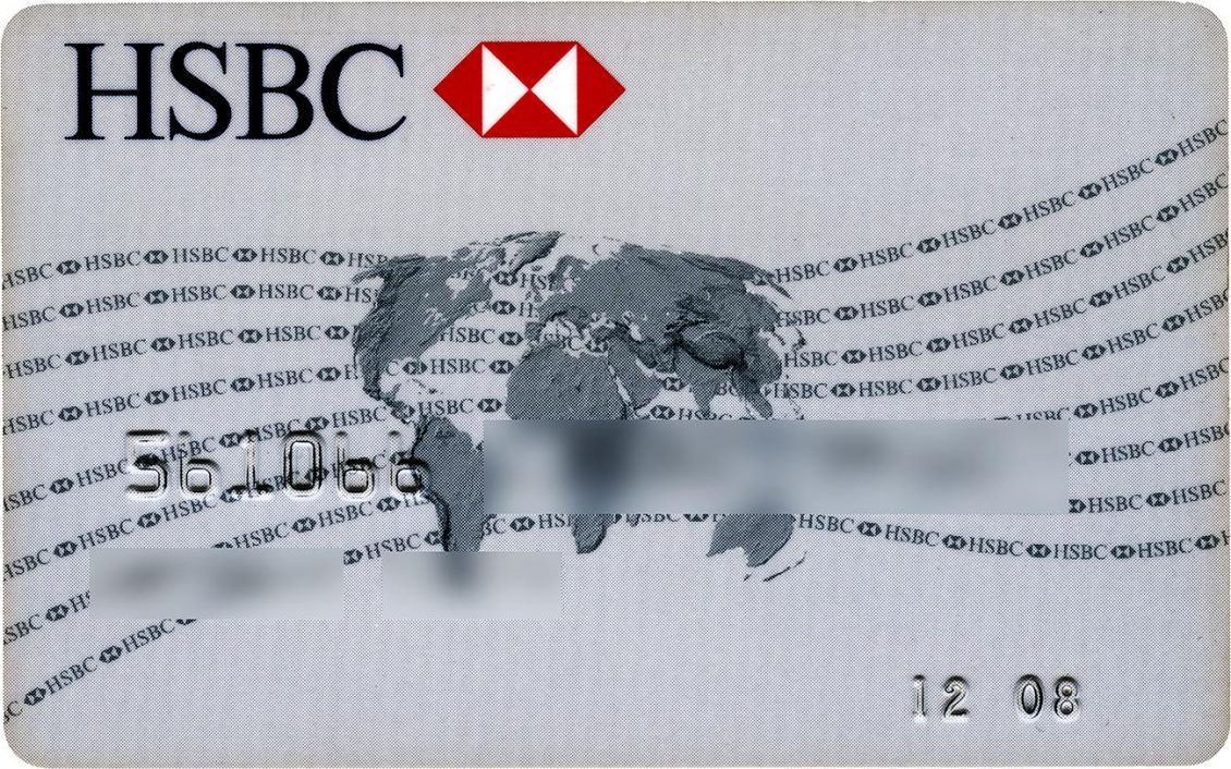 Bank card, grey with red and white logo on the top, world map in the centre and curved lines in the background.
