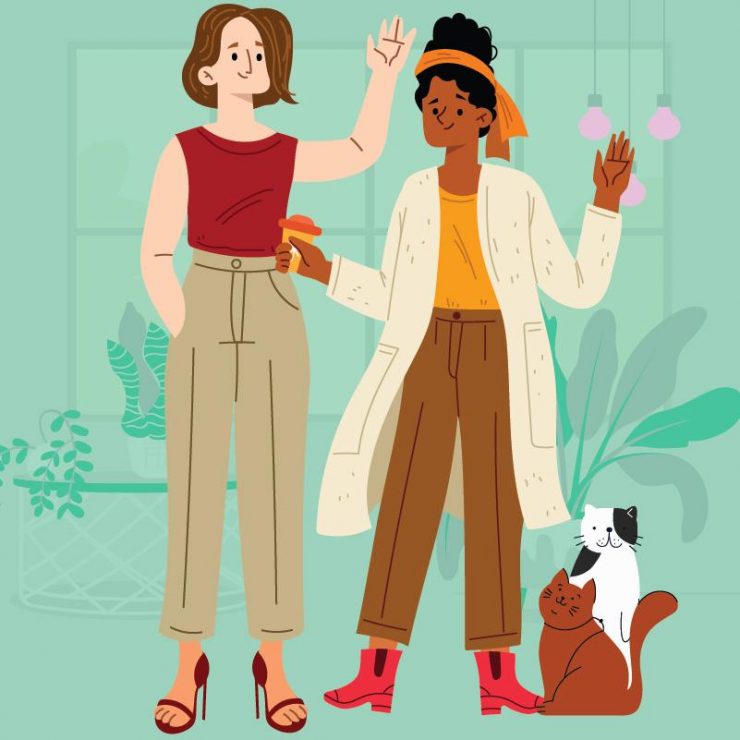 An interracial lesbian couple in their late twenties, early thirties with two cats.