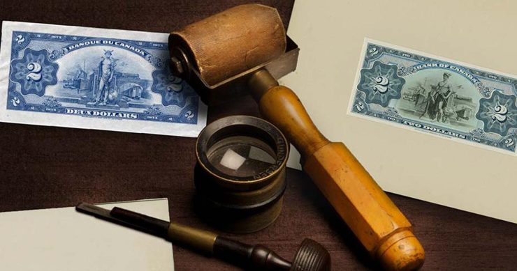 Photo, still life, engraving tools, a bank note and a bank note design model on a desk.