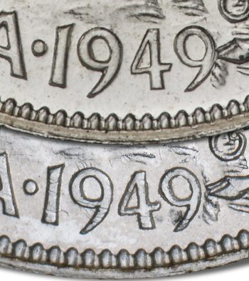 Two coins up close showing the same date but the last number of one is touching another element.