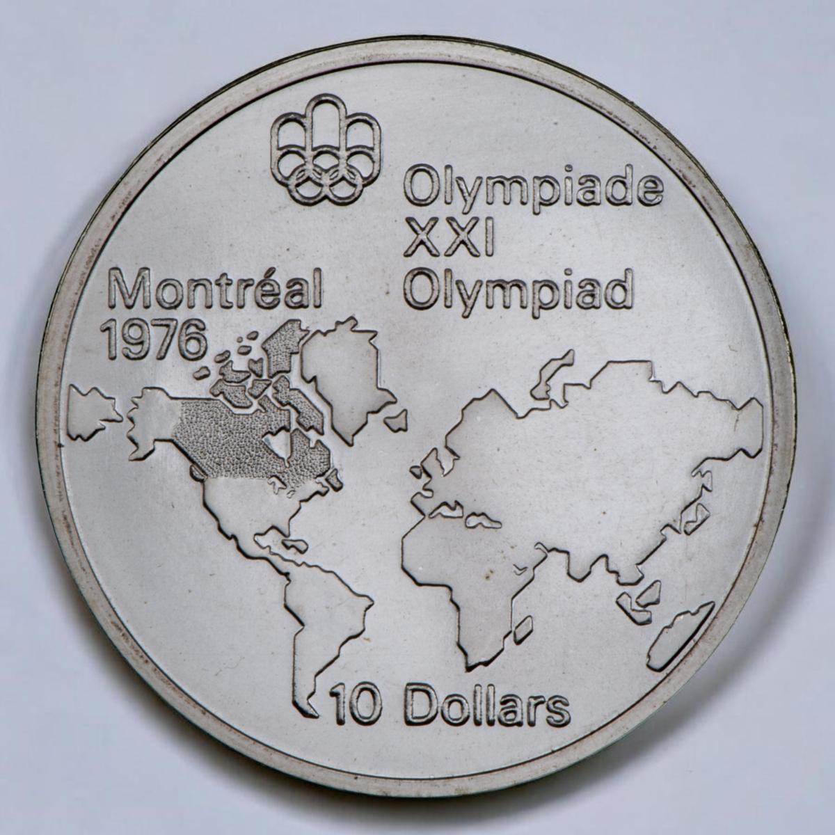 Coin, silver, a map of the world outline with Canada darkened.