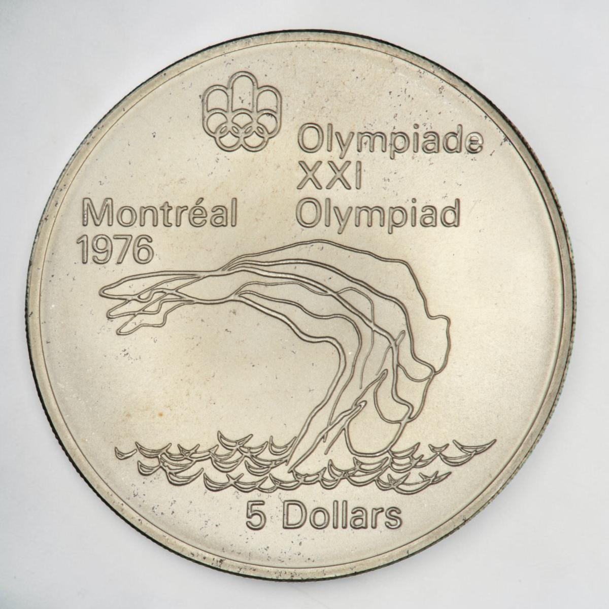 Coin, silver, stylized, repeated outlines of an athlete diving backwards into waves.